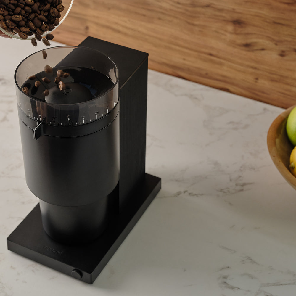 fellow opus conical burr coffee grinder on a kitchen counter
